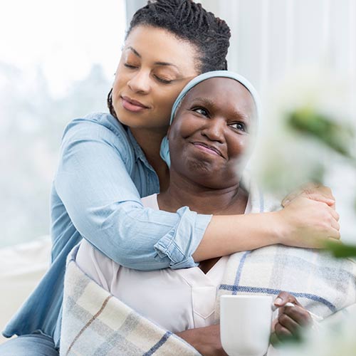 daughter hugging mother who is a cancer patient