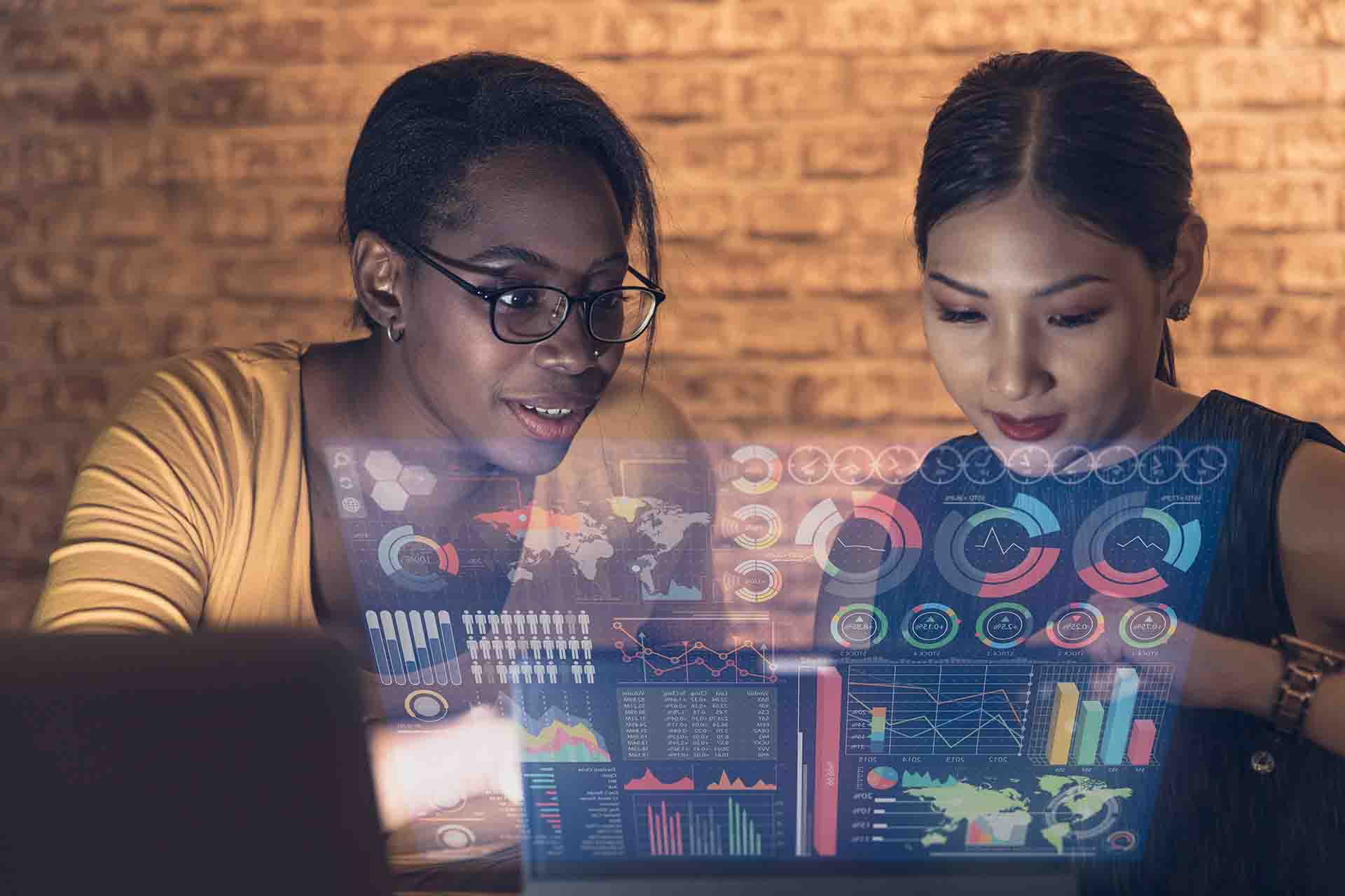 two women looking at data on hologram