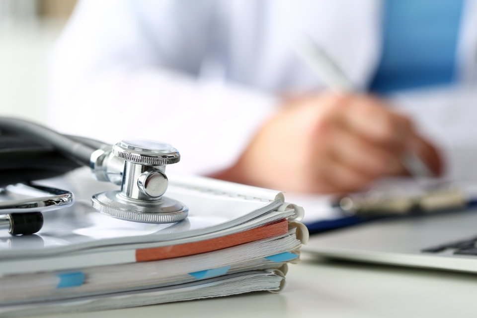 stethoscope on a stack of papers