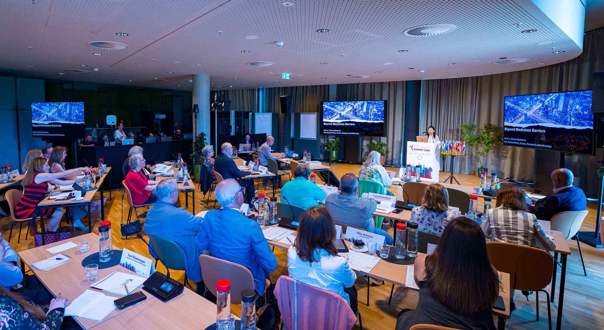 Group of scientists gather at an IMF event in a conference room to watch a presentation