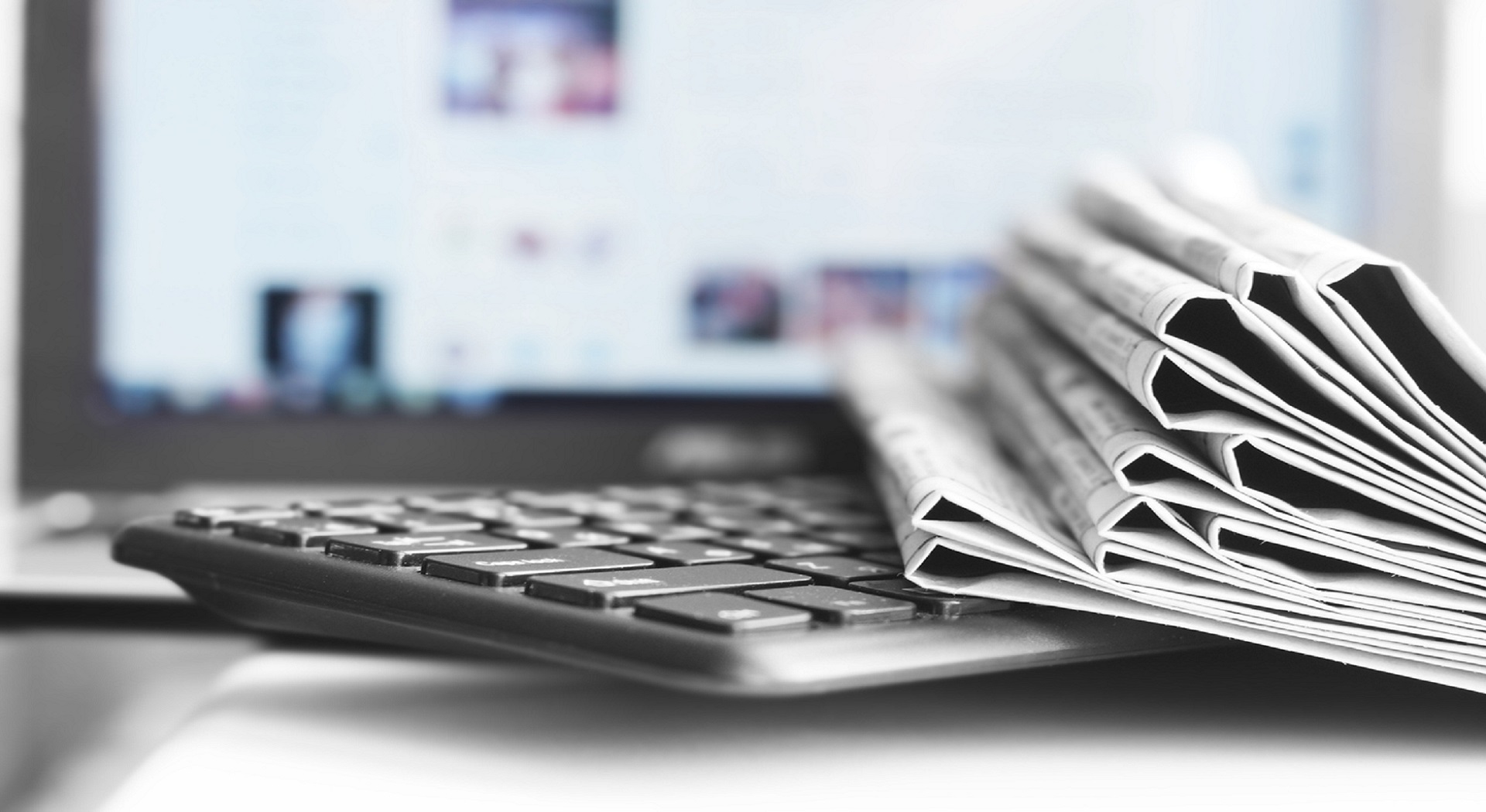 computer keyboard with newspapers