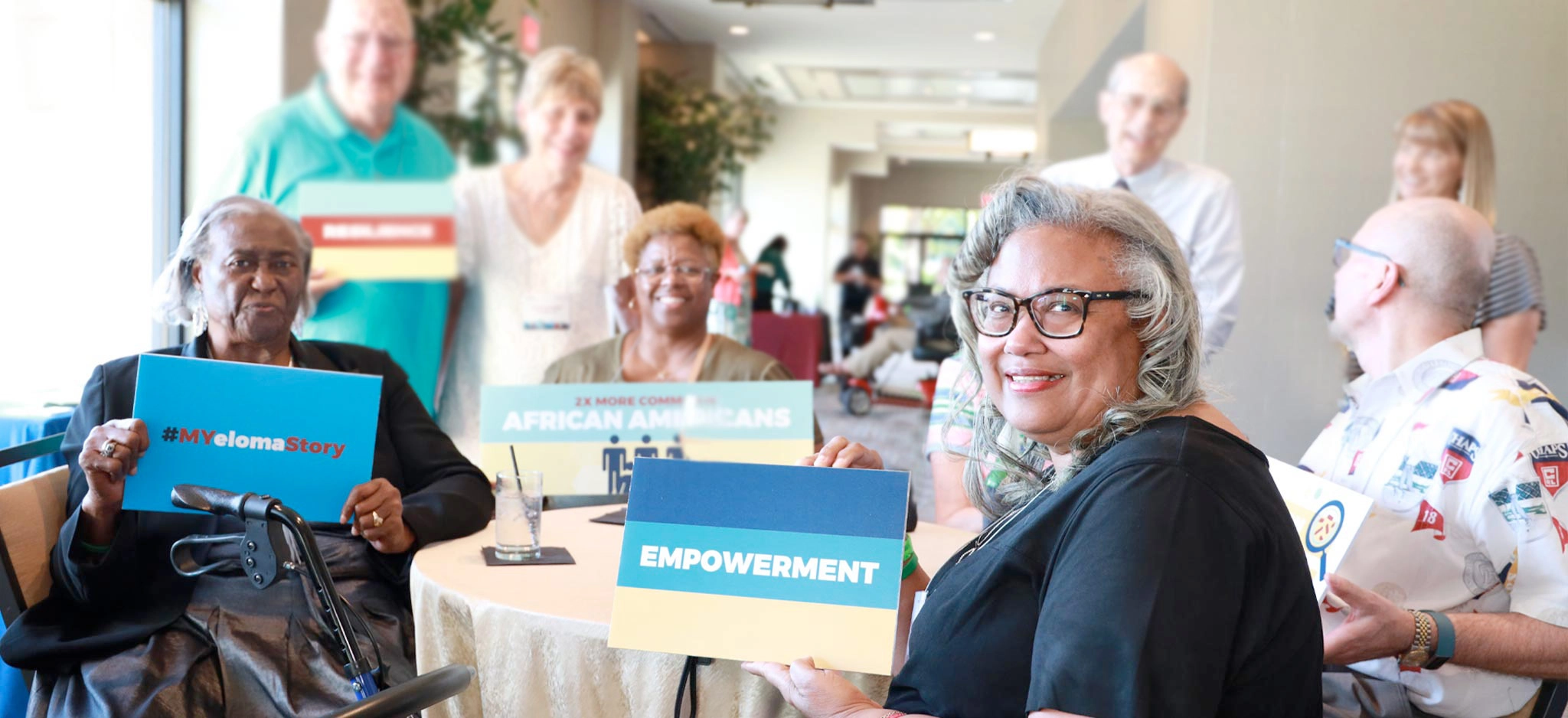 imf support group members with giving tuesday signs