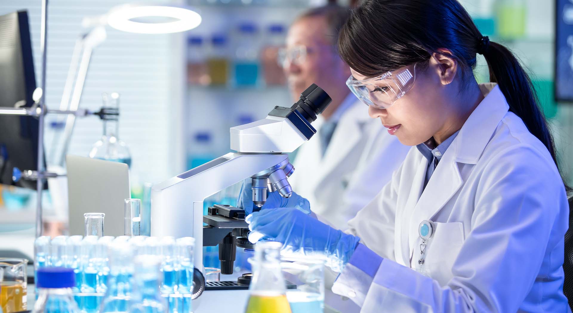 Scientist looking in microscope