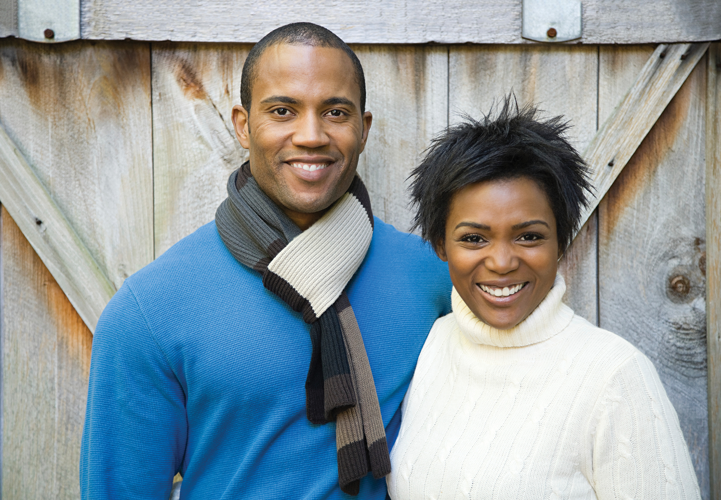couple portrait shot in front of fence
