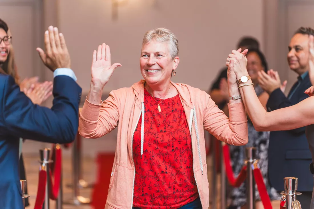 Myeloma patient high-fiving other patients