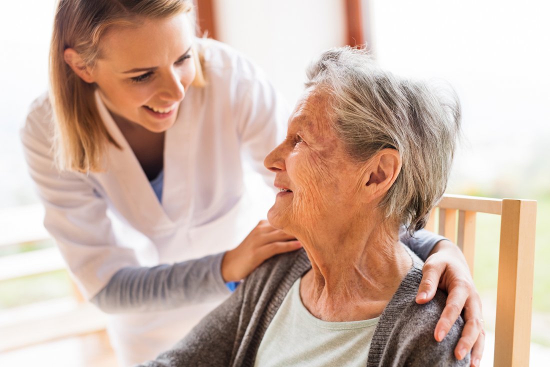 young woman with hands on shoulders of older woman