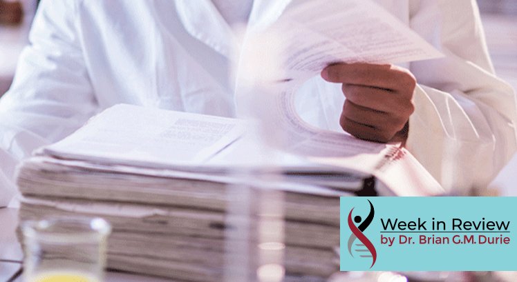 Scientist reads data from a large stack of paperwork