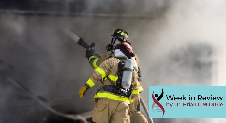 firefighters with houses and billowing smoke