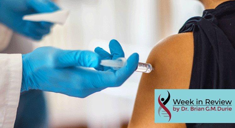 Gloved hand injects needle in arm