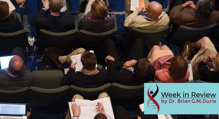 Overhead view of people sitting in chairs taking note