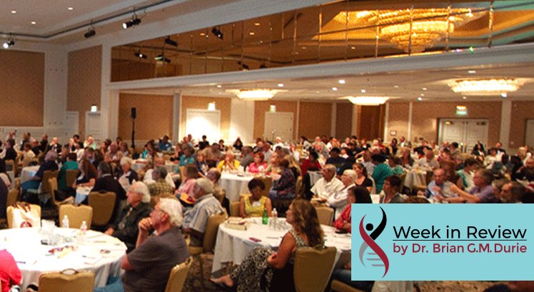 Audience sitting at tables in a convention room