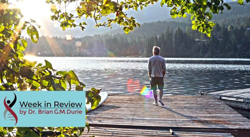 Man standing on a lakeside dock