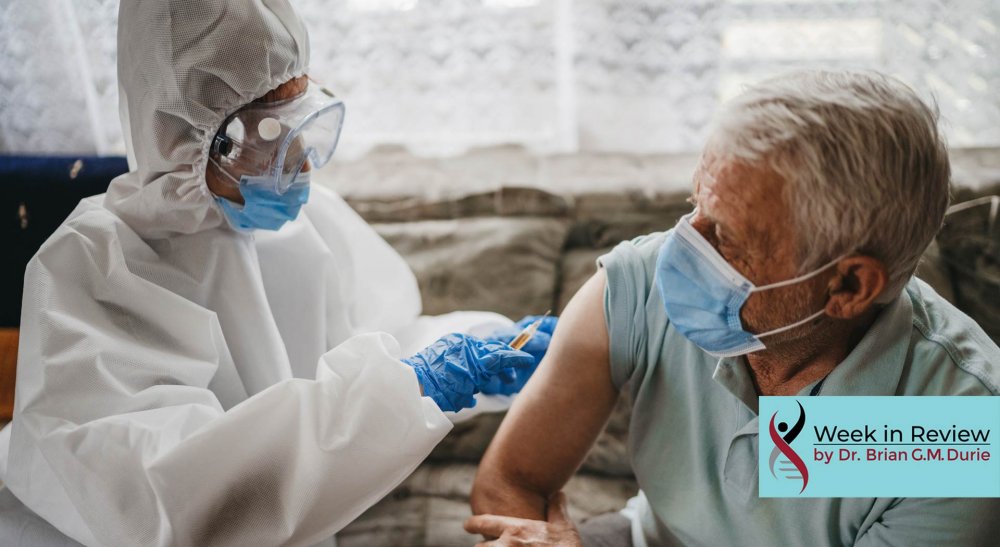 Doctor giving vaccine shot to elderly