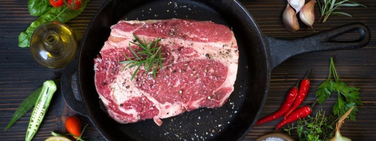 Steak and herbs on skillet