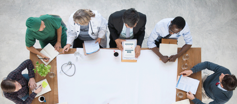 Doctors discuss and share news at table