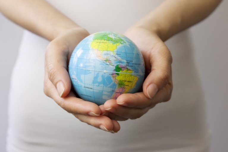 A globe held in a person's hands. 