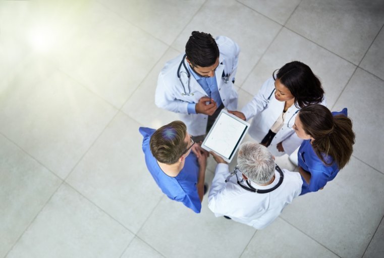 Overhead view of medical staff looking at an ipad
