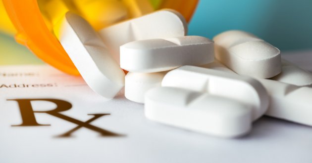 prescription pad with a bottle of pills 