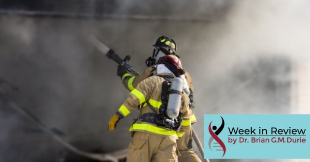 firefighters with houses and billowing smoke