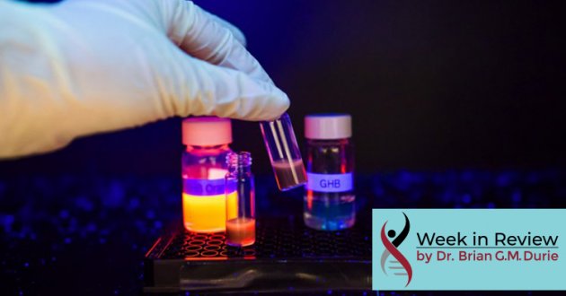 Hand in latex glove grabbing a vial