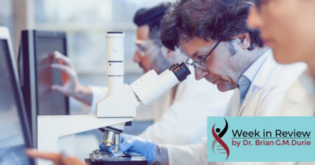 People in lab researching, looking at computer screens and microscope