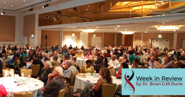 Audience sitting at tables in a convention room