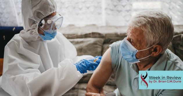 Doctor giving vaccine shot to elderly