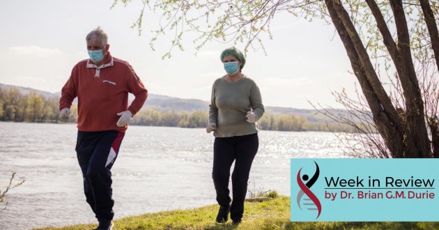 senior couple walking in masks