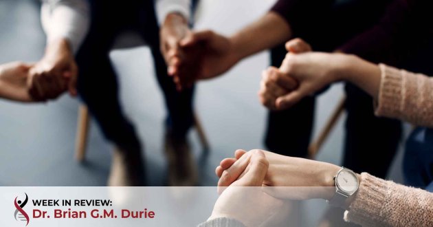 support group members holding hands during a meeting