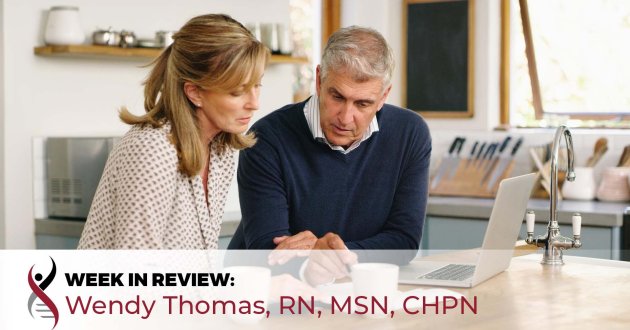 senior couple reviewing documents in front of a laptop