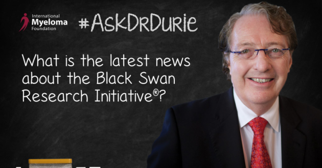Dr. Durie in front of a chalk board