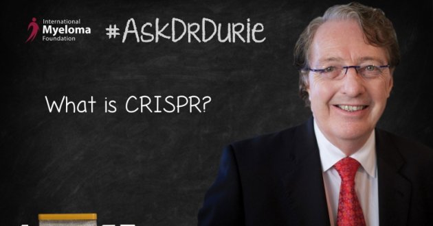 Dr. Durie in front of a chalk board