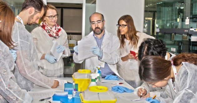 Researchers gather around a table. 