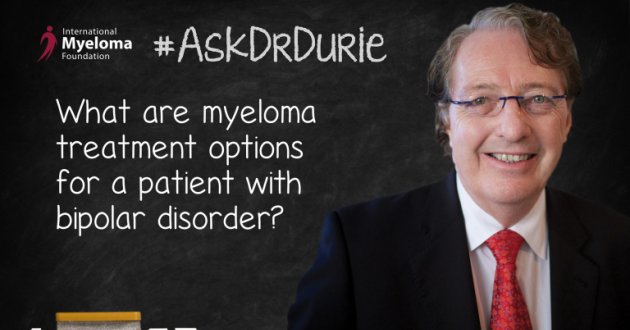 Dr. Durie in front of a chalk board