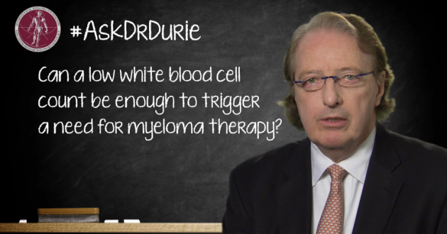 Dr. Brian G.M. Durie in front of a chalk board