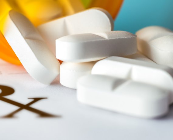 prescription pad with a bottle of pills