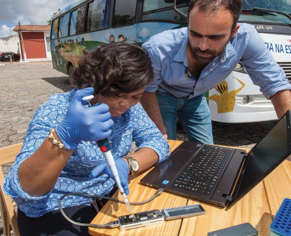 People testing blood at an outdoor table