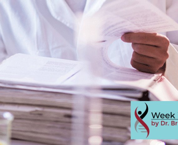Scientist reads data from a large stack of paperwork