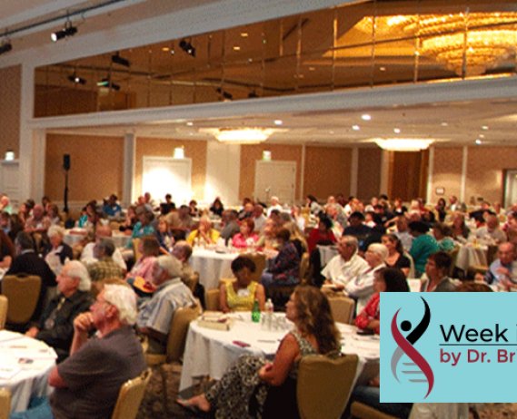 Audience sitting at tables in a convention room