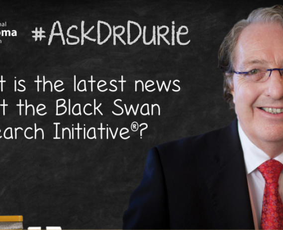 Dr. Durie in front of a chalk board