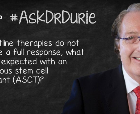 Dr. Durie in front of a chalk board