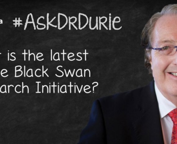 Video still of Dr. Brian G.M. Durie against chalkboard backdrop with text overlay of "What is the latest on the Black Swan Research Initiative?"