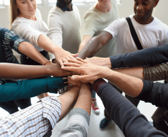 Group of people put hands in a circle