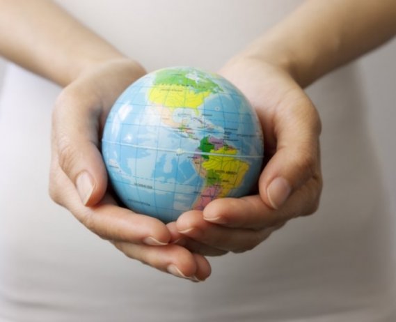A globe held in a person's hands. 