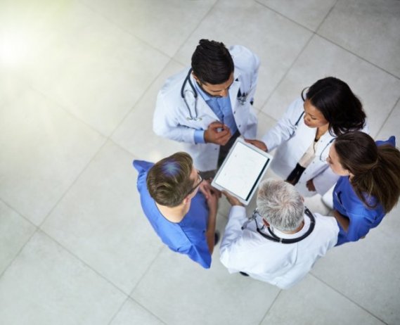 Overhead view of medical staff looking at an ipad
