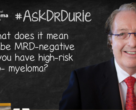 Dr. Durie in front of a chalk board