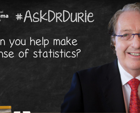 Dr.Durie in front of a chalk board