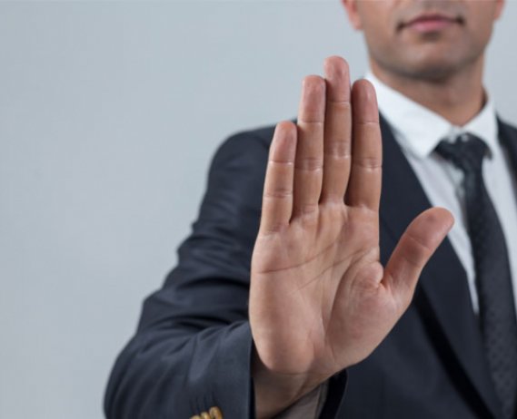 Man in business suit holding hand out, halt