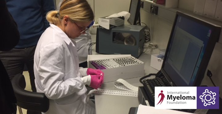 Lab technician reads data from a computer screen