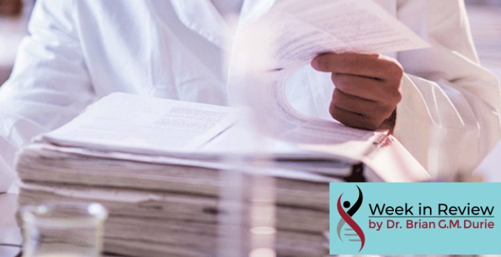 Scientist reads data from a large stack of paperwork